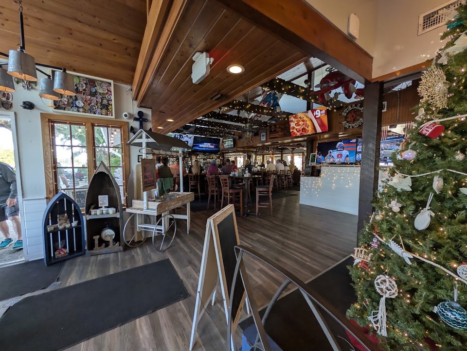 Beach-themed dining room with TVs and warm lighting.
